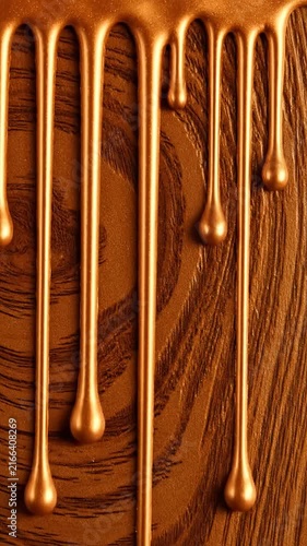 Liquid Metallic Bronze Drips Flowing Down Over Rich Dark Wooden Texture Background