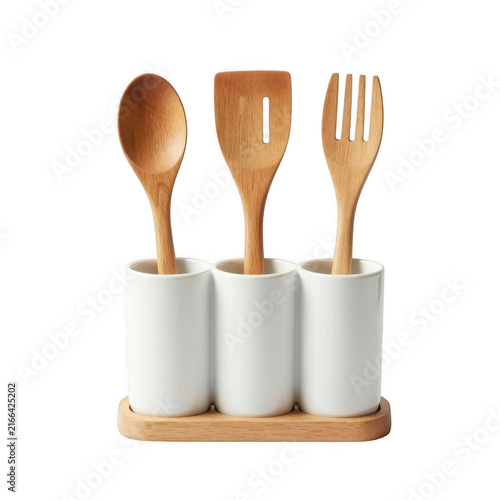 Wooden kitchen utensils set in white ceramic holders on wooden tray