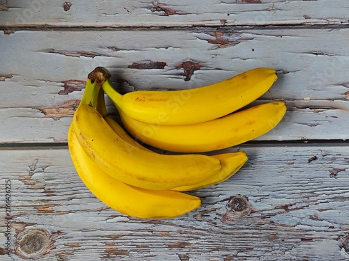 Fotografie Flat Lay Yellow Bananas Bunch on White Rustic Wooden Desk