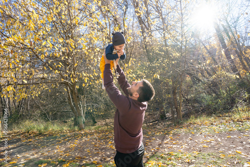 Canvastavla Father playing with baby boy in autumn forest