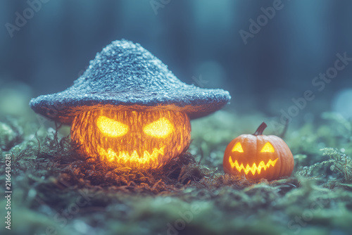 Glowing Jack-o'-lantern halloween pumpkin wearing a blue hat in a dark forest background.