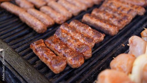 Quadro su tela Traditional Romanian Mici Grilling at a Street Food Festival
