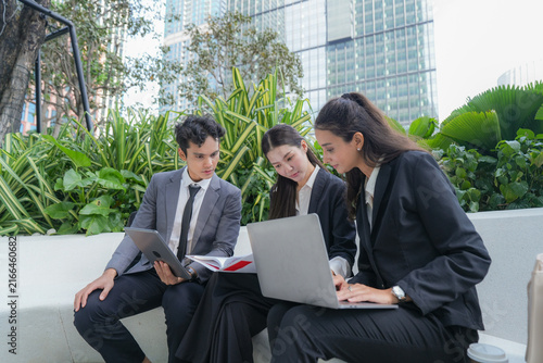 Cuadro en lienzo Three multiethnic business colleagues comparing a printed report against a lapto