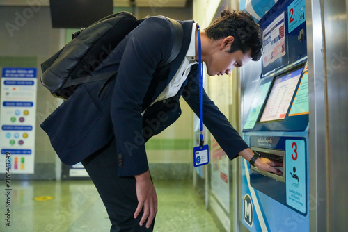Konstfotografi A confident male professional in a suit choosing a fare on a touchscreen ticket