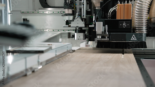 Cuadro en lienzo Automated industrial CNC machine precisely cutting wood panel
