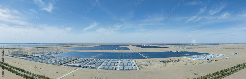 Fototapeta premium Panoramic View of Large-Scale Battery Energy Storage Power Stations, Solar Arrays and Thermal Tower in Gobi Desert