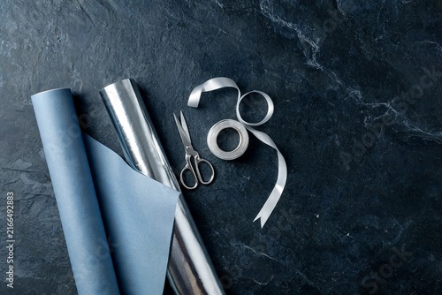 Gift Wrapping Supplies Paper Rolls Scissors On Dark Slate Background