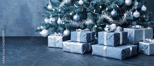 Wrapped Gifts Under Decorated Christmas Tree On Dark Slate Background