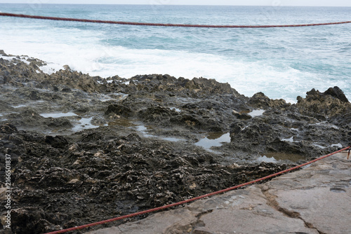 Natural limestone ledges and ocean waves along the northeastern coast of Colombia near Providencia