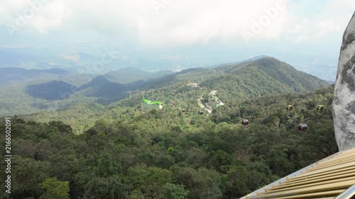Panoramic mountain landscape at Ba Na Hills in Da Nang, Vietnam, with cable cars crossing lush forested hills and a scenic mountain valley.