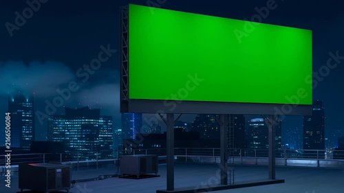 Large green billboard on rooftop with city skyline background at night for advertising display