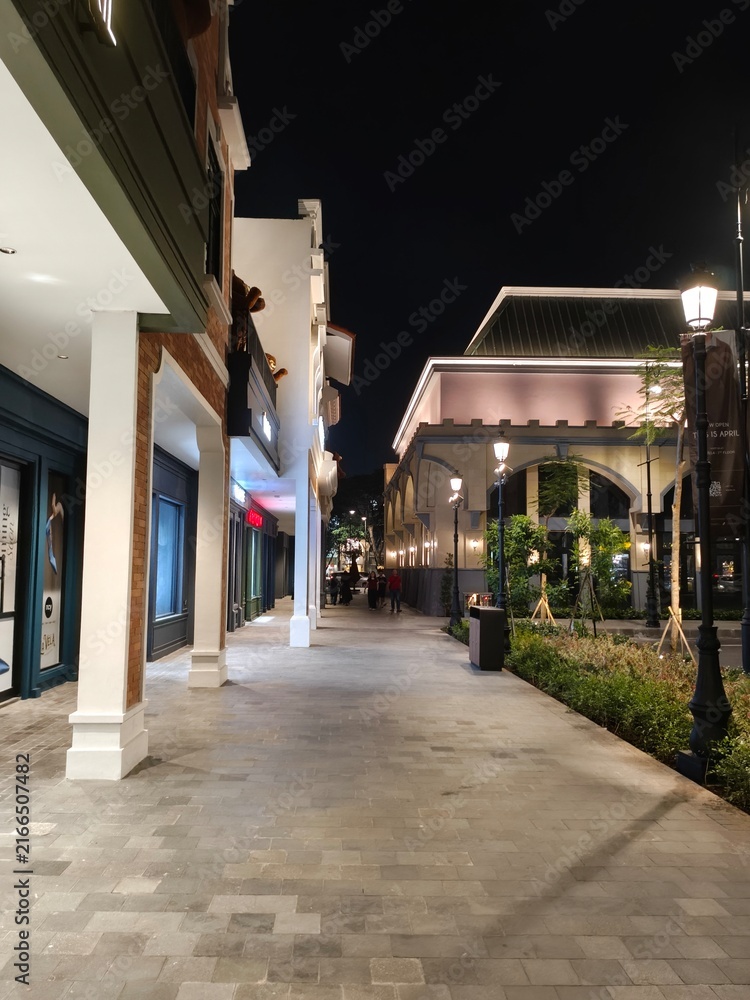 Fototapeta premium Nighttime street scene with classic architecture