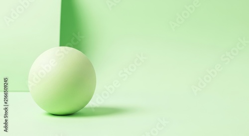 Minimalist green sphere rests on light pastel green studio background with soft shadows for clean geometric product presentation.