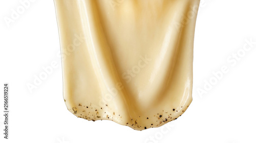 Dripping thick beige sauce with black pepper flakes.