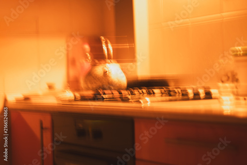 Quadro su tela Abstract warm kitchen interior with teapot and intentional camera movement blur