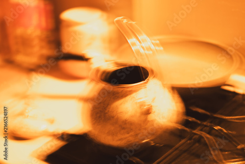 Cuadro en lienzo Abstract warm kitchen concept with teapot and dynamic intentional camera movemen
