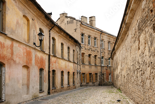 Straight cobblestone street between historic ochre buildings in Vilnius old town, lithuania travel content, old town architecture blog, city guide photography, heritage tourism marketing