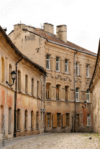 Curved cobblestone street lined with historic ochre buildings, travel content, city guide photography, heritage tourism marketing, old town architecture blog