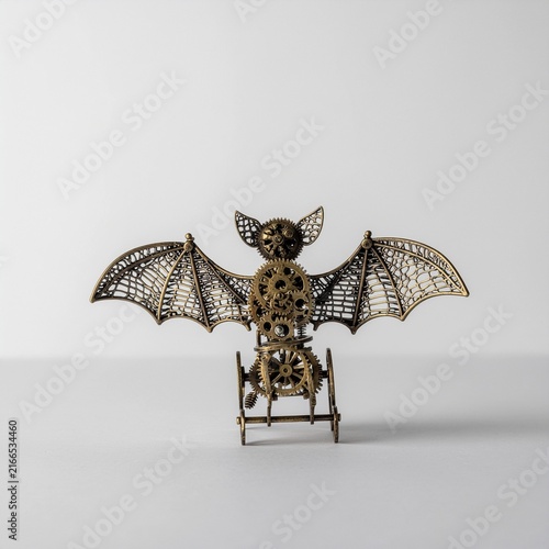 Steampunk mechanical bat sculpture on light background studio