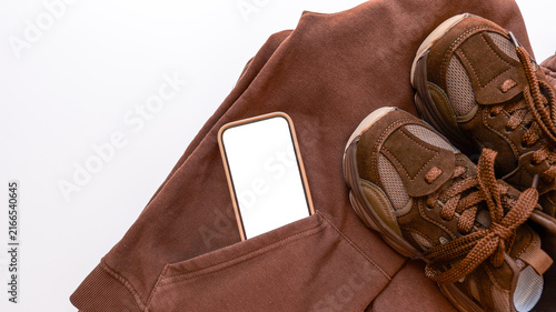Canvas Print Brown casual outfit with smartphone tucked into pocket and sneakers