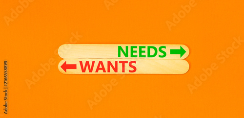 фотографія Needs instead wants words symbol