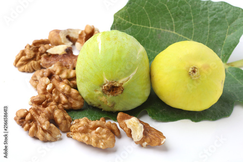 Fresh Whole Yellow Figs with Walnut Kernels and Fig Leaf Isolated on White Background
