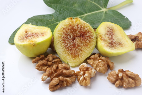 Sliced Fresh Yellow Figs with Walnut Kernels and Fig Leaf Close Up