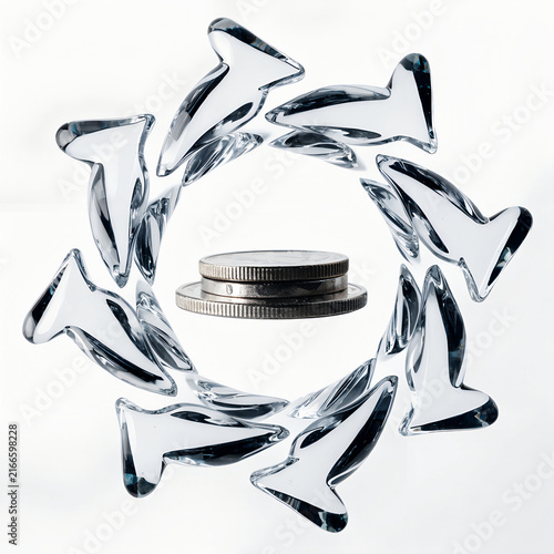 Glass sculpture with a circular design showcasing coins in the center
