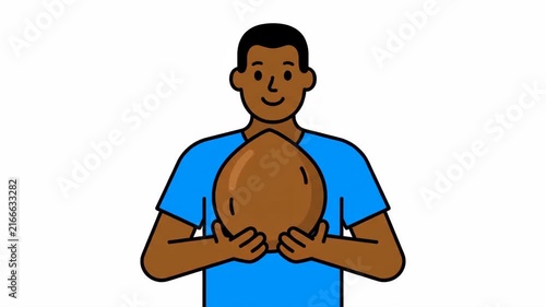 Smiling Man in Blue T-shirt Holding a Large Brown Seed or Nut