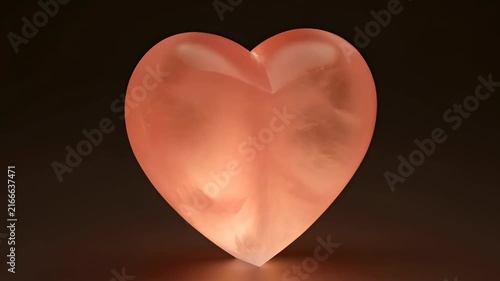 Glowing Pink Heart Sculpture Rotating on Black Background,