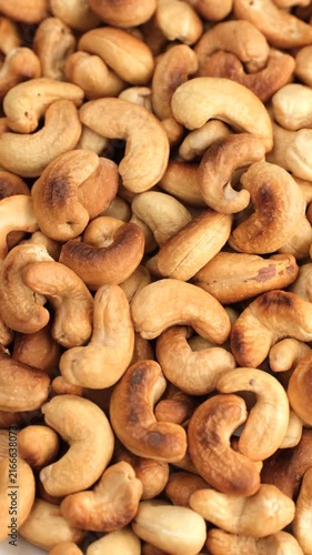 Zoom frame roasted cashews close up, rotate