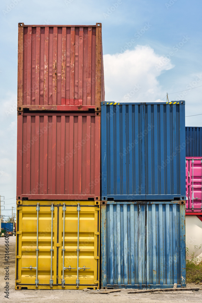 Fototapeta premium Stacked colorful cargo shipping containers in freight terminal yard