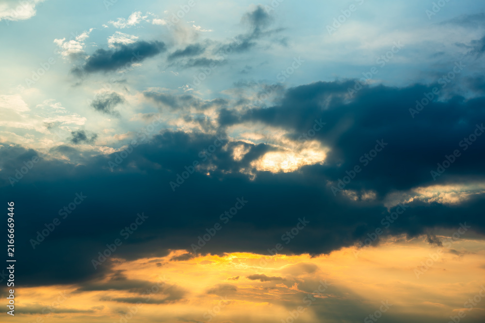 Obraz premium Dramatic sunset clouds breaking with warm golden sunlight over the mountainous landscape in Xizhi, New Taipei City, Taiwan.