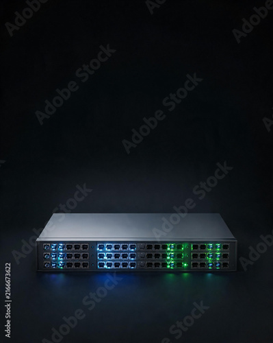 Glowing network switch with blue and green Ethernet ports on dark background