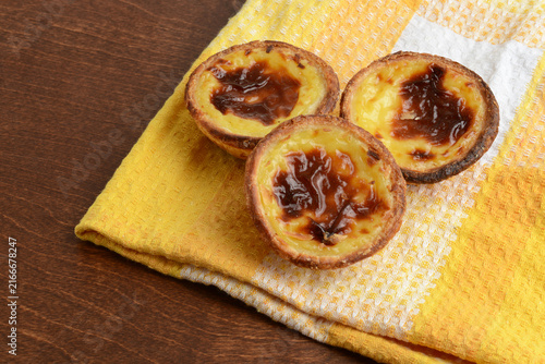  closeup Portuguese Custard Tarts Pasteis de Nata on a checkered napkin