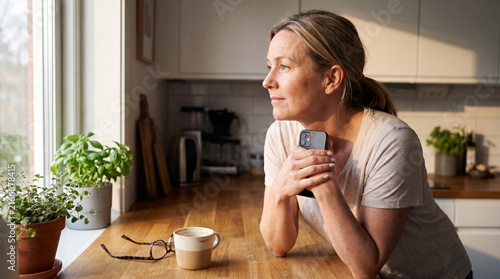 A woman has just received an important phone call and needs a few seconds to take it in