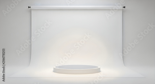 Empty white cyclorama studio backdrop with spotlight illuminating a circular stage podium for product display or photo shoots