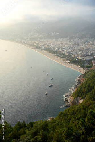 Fotografie Panoramic view of Cleopatra Beach in Alanya from high cliff, scenic Mediterranean Sea coast line with tourist yachts, beautiful coastal city skyline background in Turkey