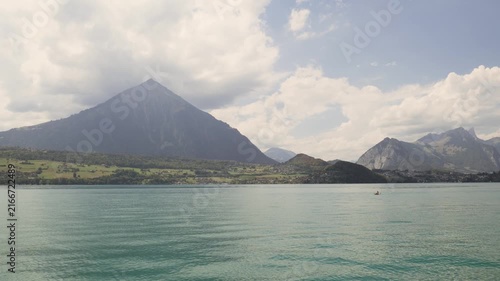 Beautiful alpine landscape featuring the turquoise waters of lake thun and the swiss alps. Switzerland