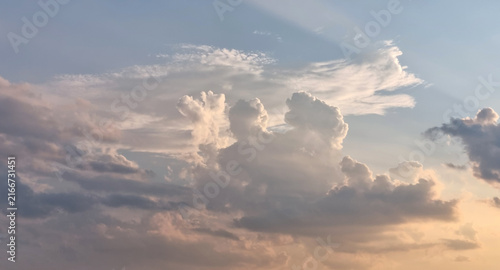 A quiet evening sky. Clouds at sunset, the sun's shadow in the sky, background for text
