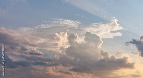 A quiet evening sky. Clouds at sunset, the sun's shadow in the sky, background for text