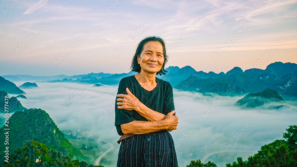 Fototapeta premium Confident woman overlooking misty mountains