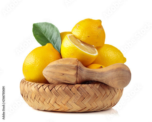 Bild auf Leinwand Fresh lemons and wooden juicer isolated on a white background.