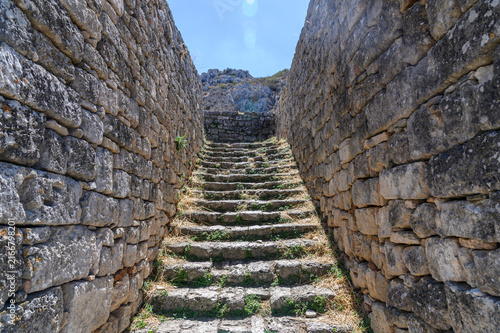 Ancient stone staircase rising between two massive walls at Acrocorinth, Corinthia, Greece
