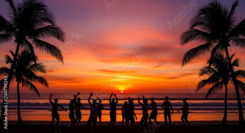 Group of friends having fun on the beach at sunset with palm trees silhouette