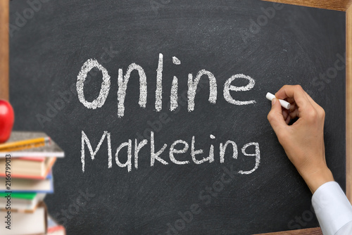 Hand writing online marketing on blackboard