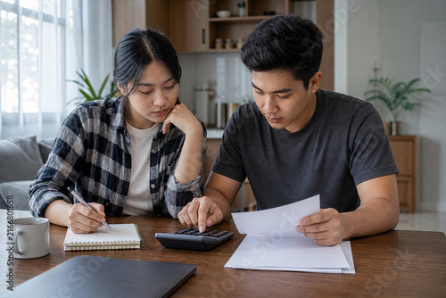 Young Southeast Asian couple planning how to repay student loans