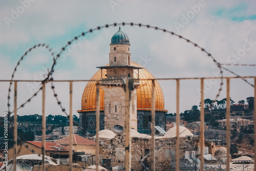 Photography Dome of the Rock behind coils of razor wire