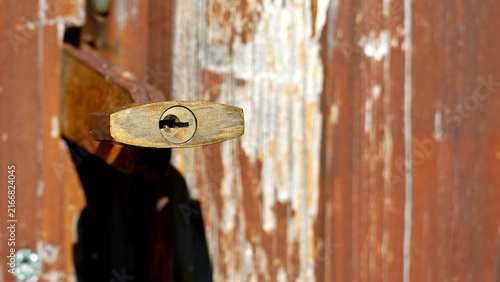 Brass Padlock on Weathered Wooden Door Keyhole View