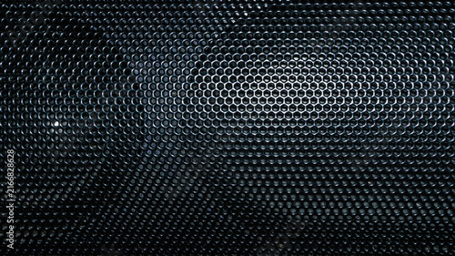 Black perforated metal speaker grille with hexagonal pattern abstract background